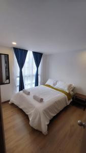 1 dormitorio con 1 cama grande y cortinas azules en Apartamento Nuevo - Centro Internacional Bogotá, en Bogotá