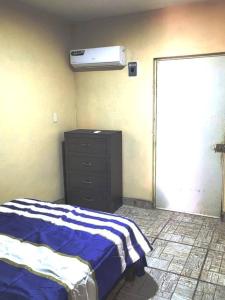 a bedroom with a bed and a dresser and a heater at Hermosa Casa en Cuatro ciénegas in Cuatrociénegas de Carranza