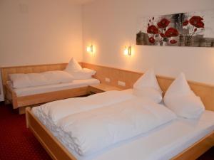 2 łóżka w pokoju hotelowym z białą pościelą w obiekcie Apartment Georg - KPL328 by Interhome w mieście Kappl