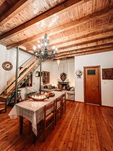 a dining room with a table and a couch at PANOS PALACE in Pramanta