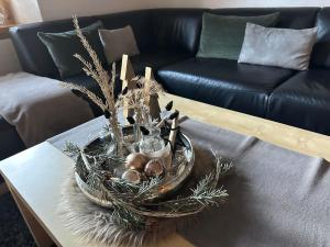 a basket of christmas decorations on a coffee table at Apartment Bergfreude by Interhome in Saas-Grund