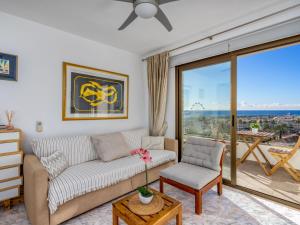 a living room with a couch and a large window at Apartment O-House by Interhome in Torremolinos +53 photos