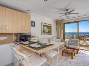a kitchen and living room with a table and chairs at Apartment O-House by Interhome in Torremolinos