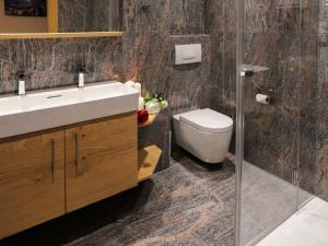 a bathroom with a sink and a toilet at Apartment Turquino C by Interhome in Zermatt