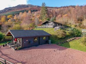 a small cabin in the middle of a hill at Chalet Highand Lodges-1 by Interhome in Spean Bridge