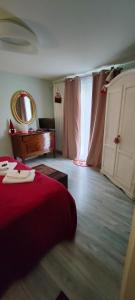 a bedroom with a bed and a mirror and a piano at La Casa della Rosa Nana in Trezzano sul Naviglio
