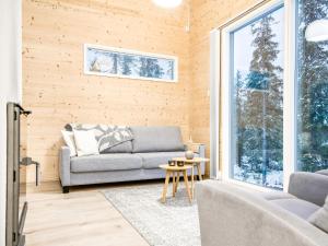 ein Wohnzimmer mit einer Couch und einem Fenster in der Unterkunft Holiday Home Rukan hukka by Interhome in Virkkula