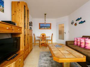 a living room with a couch and a table at Apartment Schwarz by Interhome in Ostseebad Koserow