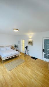 a white room with a bed and a camera at BioLocalia House Dobrogea in Baloteşti