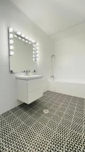 a bathroom with a sink and a mirror at BioLocalia House Dobrogea in Baloteşti