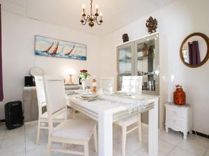 a white dining room with a white table and chairs at Villa Liou Miou Souleou by Interhome in Mouans-Sartoux