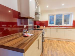 a kitchen with a wooden counter top with a appliance on it at Holiday Home Shedfield by Interhome in Drumnadrochit