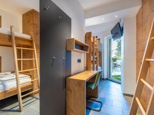 a hostel room with bunk beds and a desk at Apartment Verditz alpe maritima Ski & See - Top 1 by Interhome in Annenheim