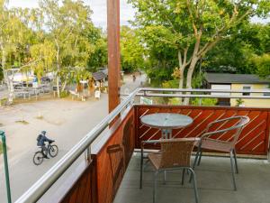 a balcony with a table and chairs and a street at Apartment App-18 Düneneck by Interhome in Zempin