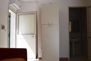 een witte kamer met een deur en een wastafel bij Quadrilocale con vista mare Pt51 in Torre dell'Orso