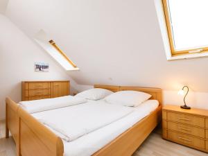 a bedroom with two beds and a window at Holiday Home Susi by Interhome in Ostseebad Koserow