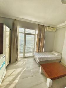 a bedroom with a bed and a view of the ocean at Deniz Hotel in Büyükçekmece