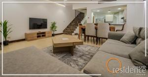 a living room with a couch and a dining room at luxury apartments in cairo , porto new cairo , nyum in Cairo