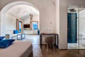 a bedroom with a bed and a bathroom with a shower at GOCCE VILLAS - Villa Degli Dei Maestrale in Vico Equense