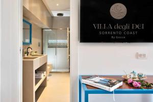 a bathroom with a sink and a counter with a table at GOCCE VILLAS - Villa Degli Dei Scirocco in Vico Equense +5 photos