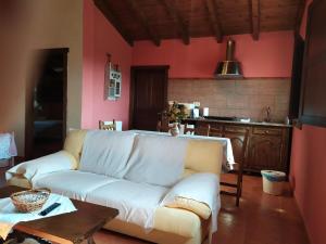 a living room with a white couch and a table at H&AP Rural Merrutxu in Ibarrangelu