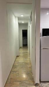 a hallway of an empty room with a refrigerator at Apartamento Córdoba FAMORCAS in Almodóvar del Río