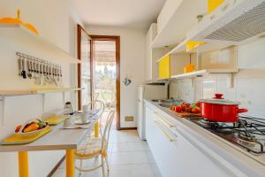 a kitchen with a counter top with a pot on the stove at Cinzia Apartment Front Beach - Happy Rentals in Sirmione