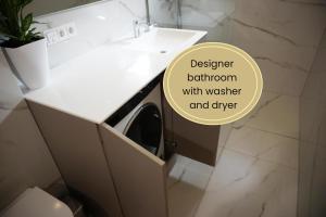 a bathroom with a sink and a washing machine in a drawer at Greenline by Gregory - Apartment mit Garten in Mainz, ZDF Nähe in Mainz +8 photos
