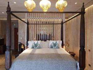 a bedroom with a canopy bed with two chandeliers at Impression Nordic Manor Club in Ren'ai