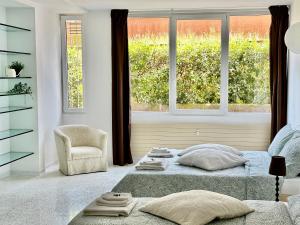 a bedroom with a bed and a chair and a window at Apartments Navigli in Milan
