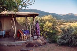 a man standing in front of a house at Maji Moto Eco Camp in Maji Moto