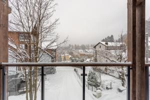 a view of a snow covered street from a balcony at Centrum Park 2 Apartament 2 in Szklarska Poręba