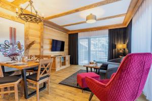 a living room with a table and chairs and a couch at Centrum Park 2 Apartament 2 in Szklarska Poręba