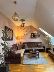 a living room with a couch and a table at KENT Apartments in Prishtinë