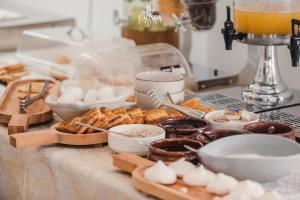 a table with a bunch of food on a counter at La Onda Hotel Durres in Durrës