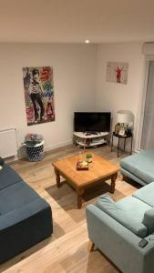 a living room with a couch and a coffee table at Cœur de ville Loverien in Louviers