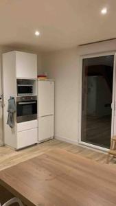 a kitchen with a white refrigerator and a stove at Cœur de ville Loverien in Louviers