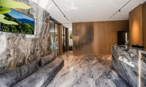a lobby of a hotel with a stone wall at La Onda Hotel Durres in Durrës