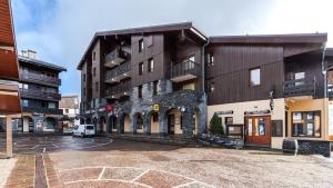 an empty parking lot in front of a building at les arcades a37 4 pers in Doucy