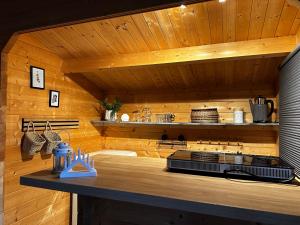 a kitchen with wooden walls and a counter top at Glamping Hütte Hygge in Winterberg