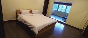 The Wild Fo'rest Resorts tesisinde bir odada yatak veya yataklar