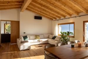 a living room with a couch and a table at Colago Private Villas Lake Garda in Toscolano Maderno