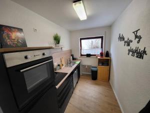 a kitchen with a sink and a stove top oven at Schönes Ruhiges Appartement in Crailsheim