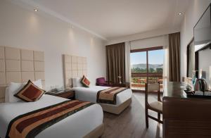 Ένα ή περισσότερα κρεβάτια σε δωμάτιο στο Pyramisa Island Hotel Aswan