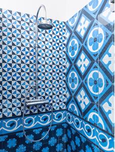 a bathroom with a shower with blue and white tiles at Apartment close to campus in Nijmegen