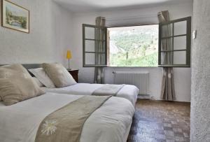 Voodi või voodid majutusasutuse Le Moulin en Provence toas