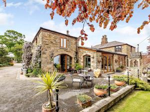 an exterior view of a stone house with plants at 1 bed in Holywell 82277 in Whitford