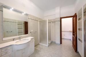 a white bathroom with a sink and a shower at Tramontana in Celle Ligure