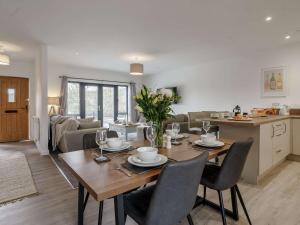 a dining room and kitchen with a table and chairs at 2 Bed in Usk 82392 in Trostrey