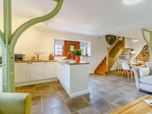 a kitchen and living room with a staircase in the background at 2 bed in Nantyglo 82706 in Nantyglo